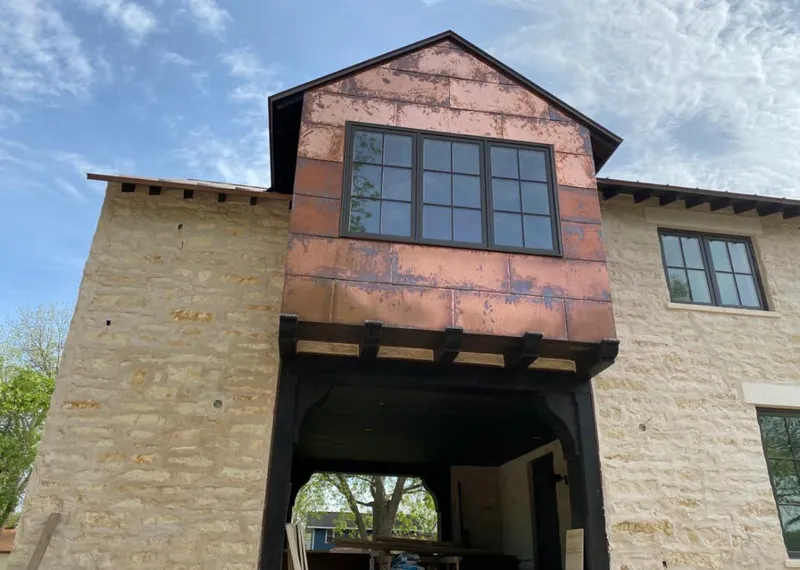 Copper metal panel facade on a stone building for Roof Repair in Bluffton