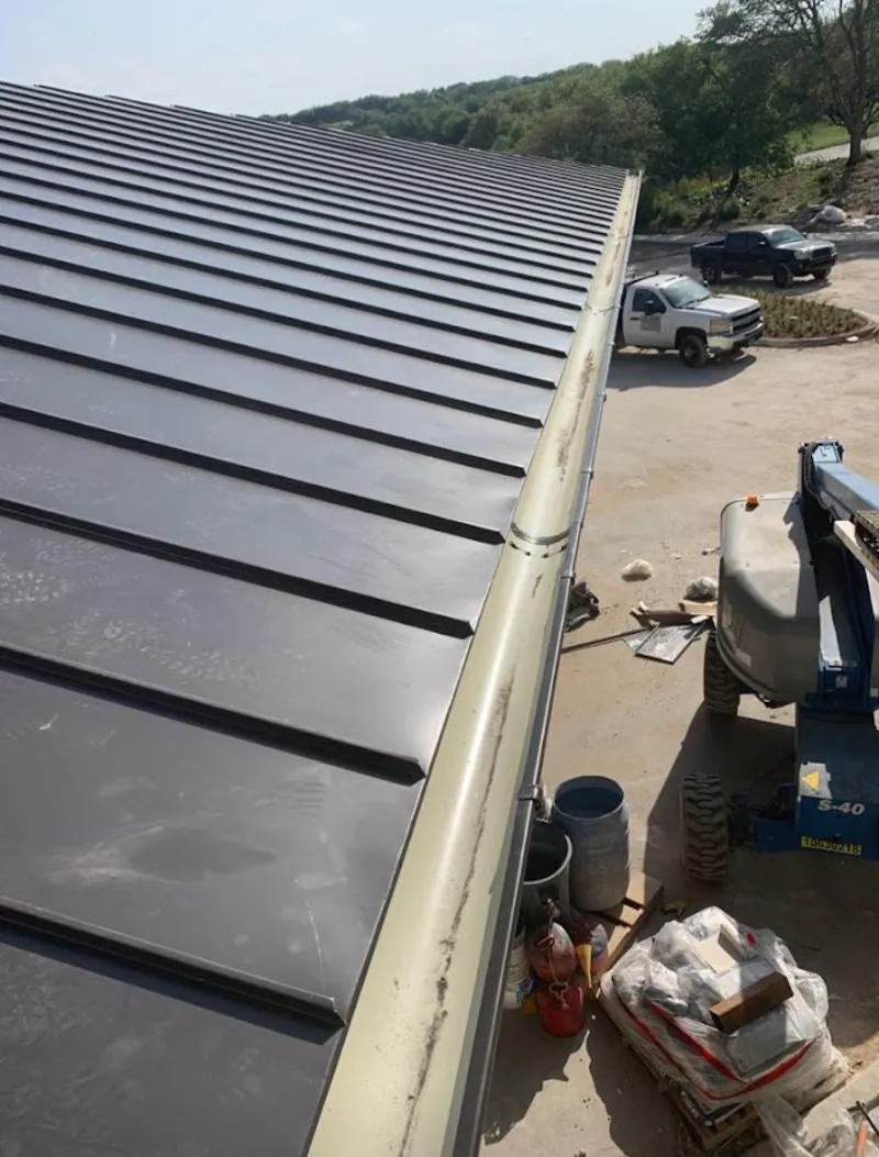 Standing seam panel and gutter detail on a metal roofing jobsite in Bluffton